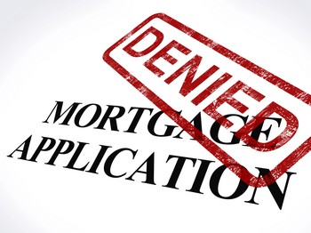 A red stamp stating Denied Mortgage Application signifies the denial of a mortgage request, conveying disappointment.